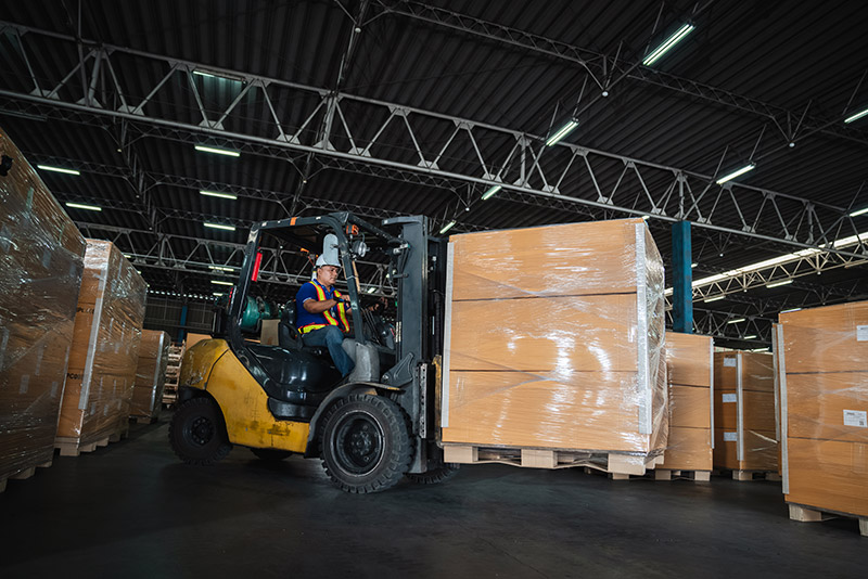 forklift truck lifting load in warehouse