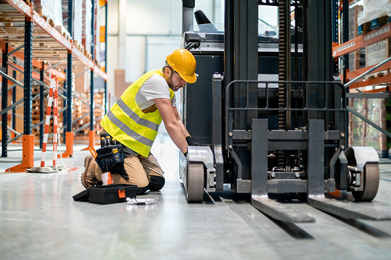 mechanic repairing forklift