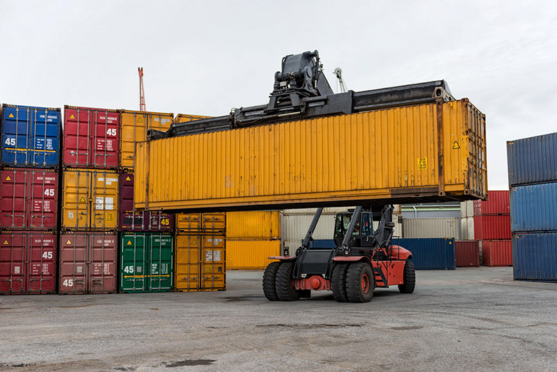 lift truck handling a container in a port