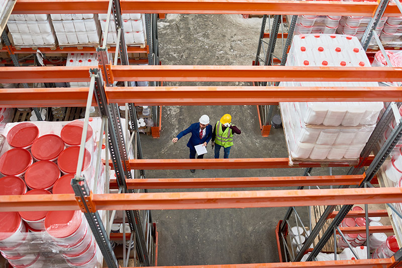 Two persons discussing pallet rack design
