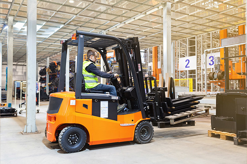 Person seated while driving a sit-down forklift